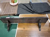 Front view of wooden wall shelf with two brackets attached