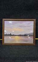 Front view of framed sunset landscape painting