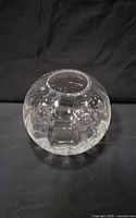 Front view of clear spherical vase showing dimple pattern