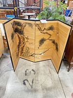 Front view of folding screen showing painted design