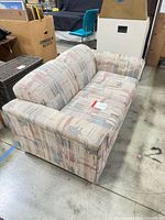 Angled view of full loveseat showing upholstery and structure