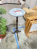 Full view of marble top pedestal table