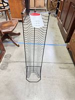 Full view of black metal CD rack showing overall structure