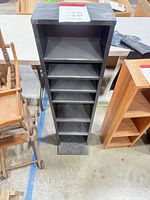 Full view of black multimedia tower showing six shelves