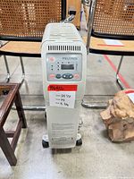 Front view of Pelonis oil heater showing control panel and dimensions label