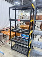Full view of five-tier black plastic shelving unit with yellow corners