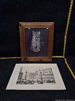 Framed leopard print and separate Venice lithograph laid flat
