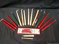 Assorted loose taper candles fanned out with boxed set displayed