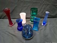 Group shot of all seven colored glass vases