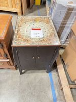 Front angled view of cabinet next to other furniture