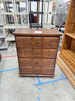 Full view of carved wood chest with four drawers
