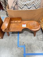 Full view of wooden cobbler's bench table showing overall design and condition