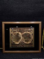 Front view of framed gold foil world map showing design and frame