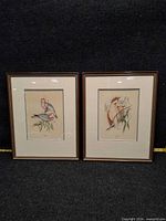 Both framed prints standing side by side