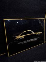 Front view of framed Pirelli Porsche advertisement showing image, text, and overall condition