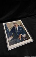 Full view of color portrait print of John F. Kennedy in sleeve