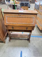 Front view of closed secretary desk showing overall form
