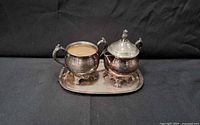 Sugar bowl and creamer on tray showing overall set