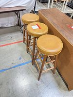 three matching bar stools beside counter