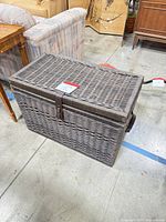 Closed wicker trunk showing exterior weave and strap