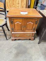 Front view of wooden nightstand closed