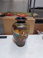 Front view of hand-painted Japanese Satsuma style vase showing robed figure and decorative motifs