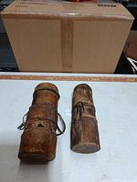 Both wooden containers standing upright showing overall form and condition