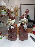 Front view of both brown plastic bunny figures with bows