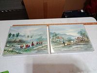 Both framed pictures side by side showing artwork and frames