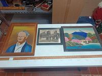 Overview of all three framed artworks on table