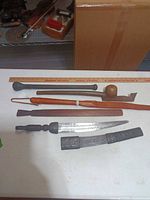 Overview of all five items laid beside ruler