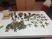 Full lot overview on table showing soldiers, planes, vehicles, cannons, tents