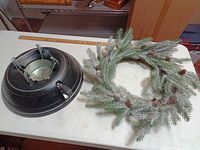 Tree stand and wreath on table for overall view