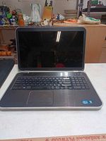 Open Dell Inspiron laptop showing keyboard and 17-inch screen