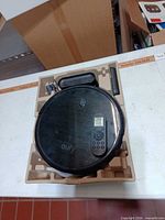 Top view of RoboVac 11S in molded tray with charging dock and power adapter
