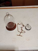 All three items: stopwatch, dome with base, chain