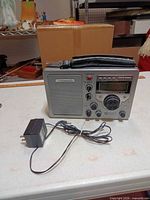 Front view of Grundig S350 radio with AC adapter laid out