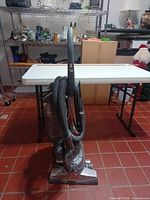 Side view Kirby Sentria vacuum upright with hose attached