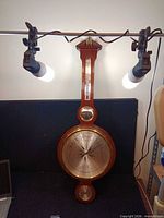 Full front view of mahogany banjo weather station
