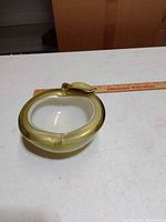 Top view of apple ashtray showing shape, interior, stem and leaf