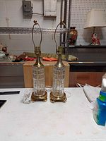 Pair of crystal column brass base table lamps with harps and cords