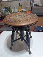 Full view of stool showing seat, legs, and finish