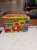 Front of 2012 Rock 'Em Sock 'Em Robots box