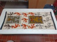 Full view of textile showing overall design and size relative to table