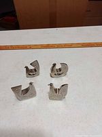Front view of four silver-tone bird sculptures
