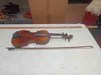 Violin and bow full view with ruler for scale