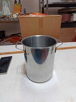 Front view of stainless steel pot showing handles and polished finish