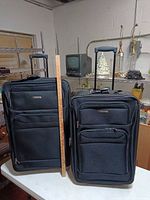 Front view of both Leisure suitcases with ruler for scale