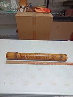 Full view of bamboo valiha showing length and etched designs