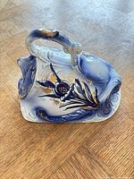 side view showing floral decoration, handle, molded details